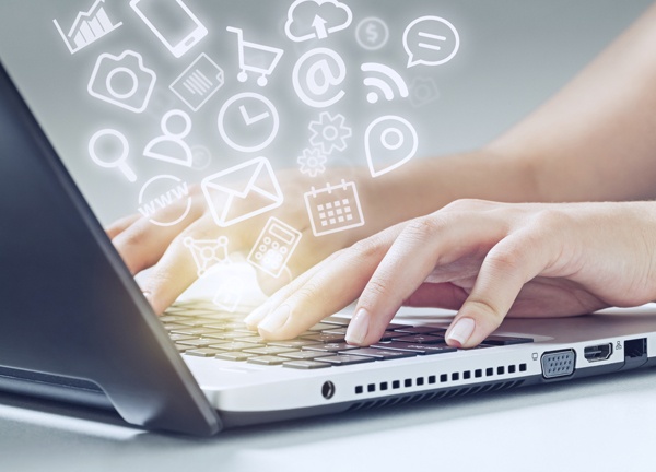 woman typing on laptop and media icons fly off woman typing on laptop computer and media app icons flying.